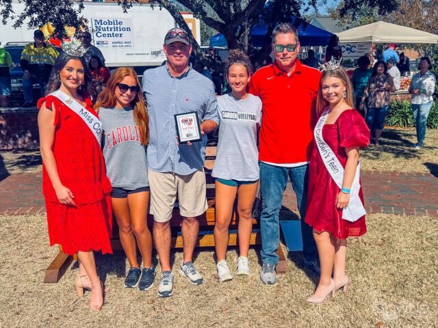 There was a chili cook-off event in Camden that also included a competition for Miss Camden Teen and Queen. After the event, there was a group photo taken to commemorate and celebrate the winners of these various competitions.