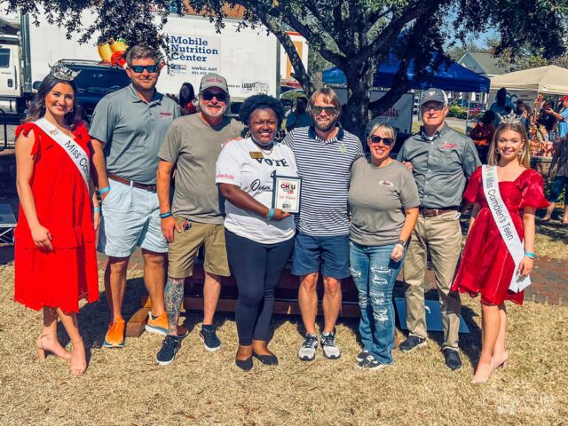 There was a chili cook-off event in Camden that also included a competition for Miss Camden Teen and Queen. After the event, there was a group photo taken to commemorate and celebrate the winners of these various competitions.