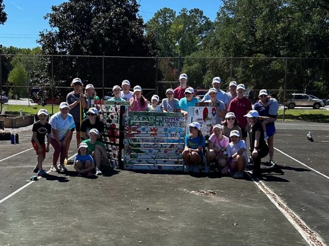 It's a picture of a group of people who are volunteering to help out in the community garden.